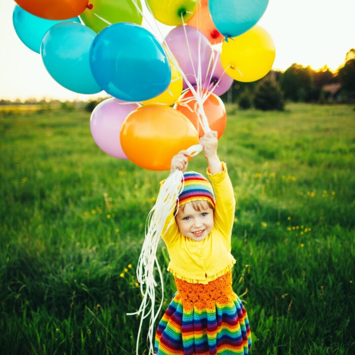 little girl with colorful balloons